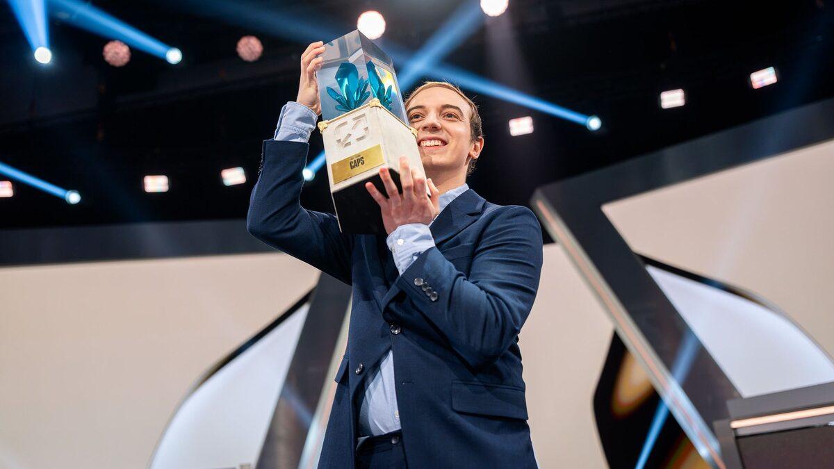 Caps holding his Hall of Legends trophy at the 2026 induction ceremony