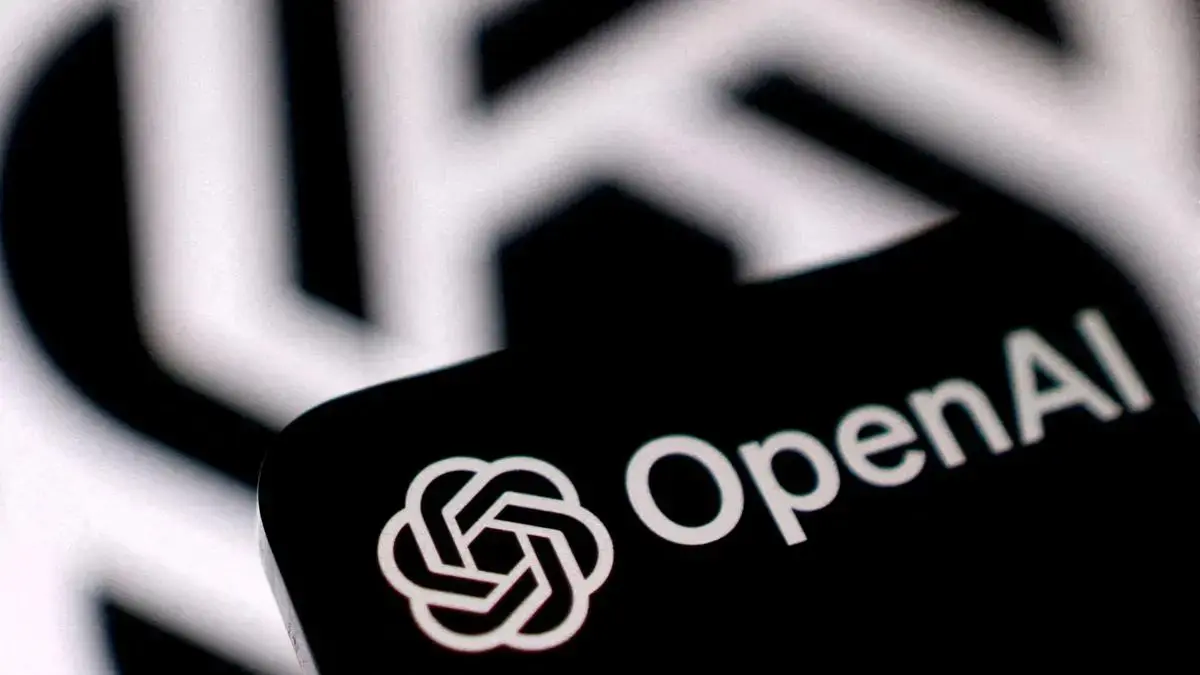 OpenAI logo displayed on a smartphone in front of a larger OpenAI symbol
