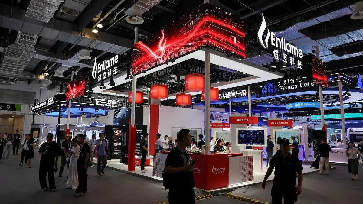 Visitors walk past the Enflame booth at the World Artificial Intelligence Conference in Shanghai