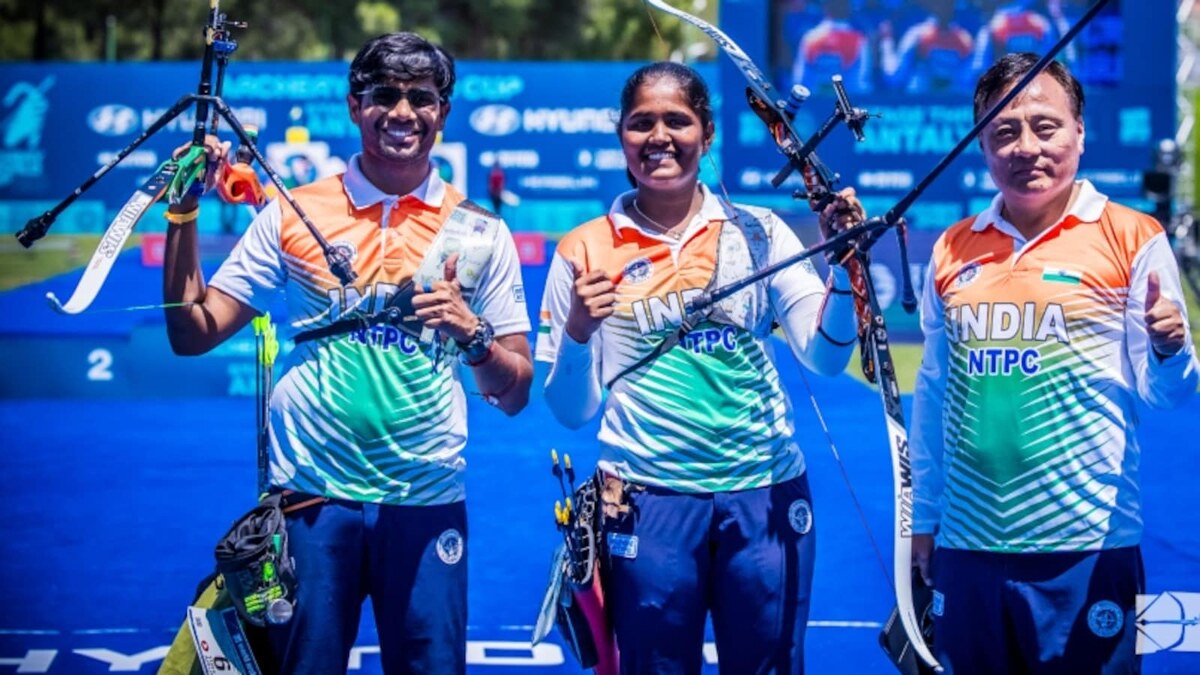 Indian recurve archers Dhiraj Bommadevara, Kumkum Mohod and team staff posing with bows at a 2026 World Archery event