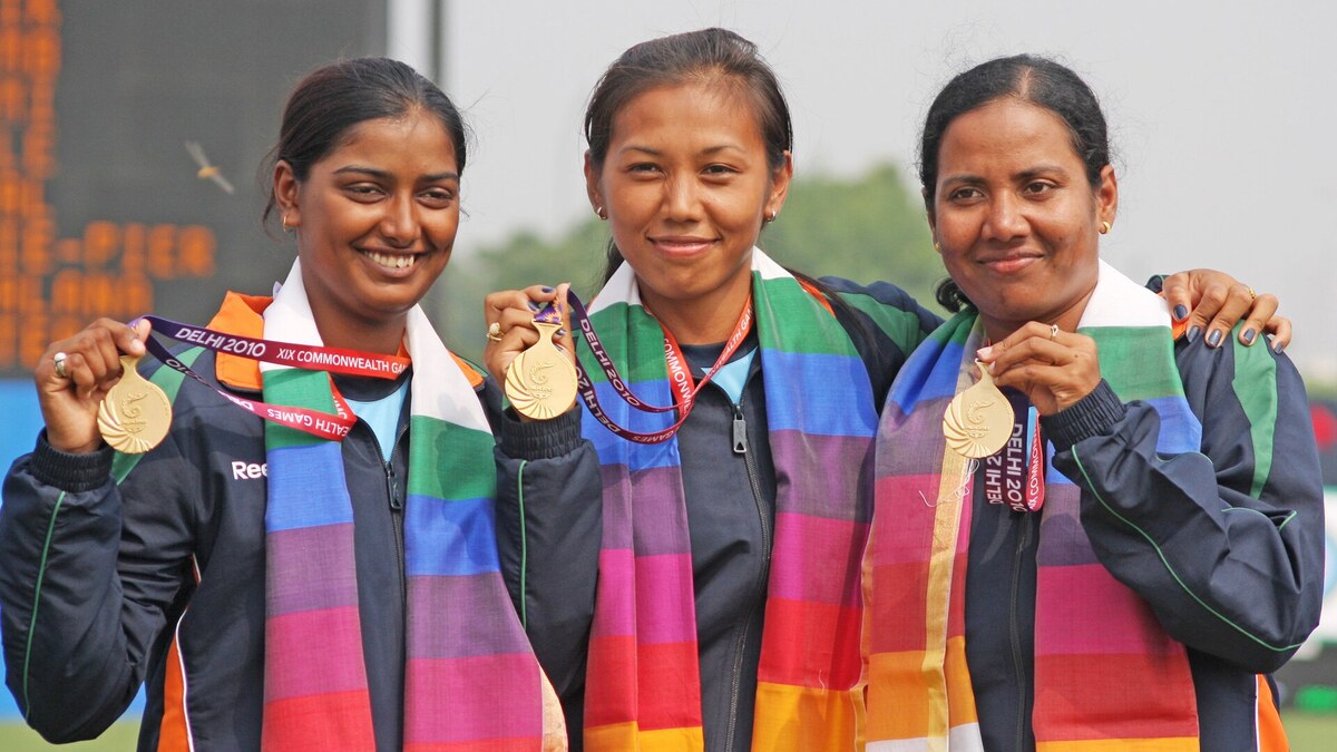 Three Indian women archers displaying their medals after a team event