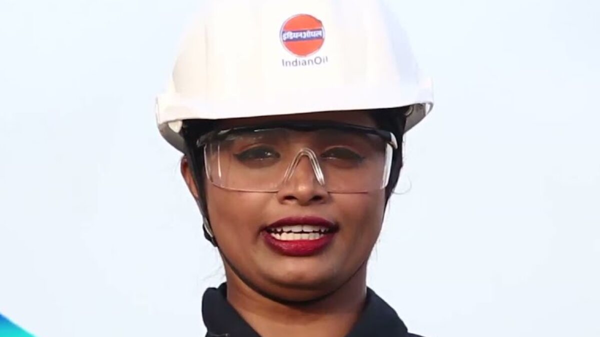 An IndianOil refinery worker wearing a safety helmet and protective glasses