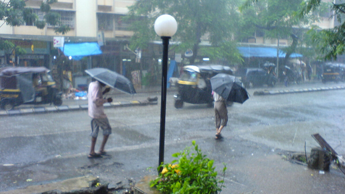 Heavy monsoon rain falling over an Indian city road