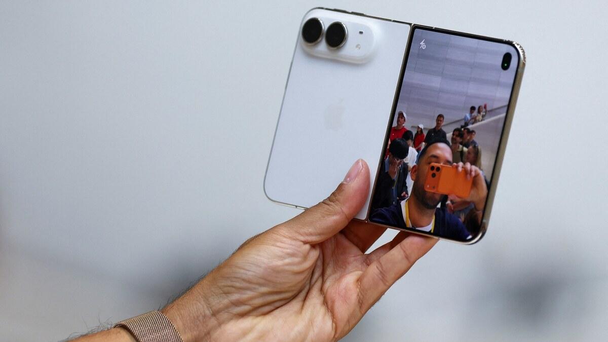 A person holds the open iPhone Duo foldable during Apple's September 2026 launch event
