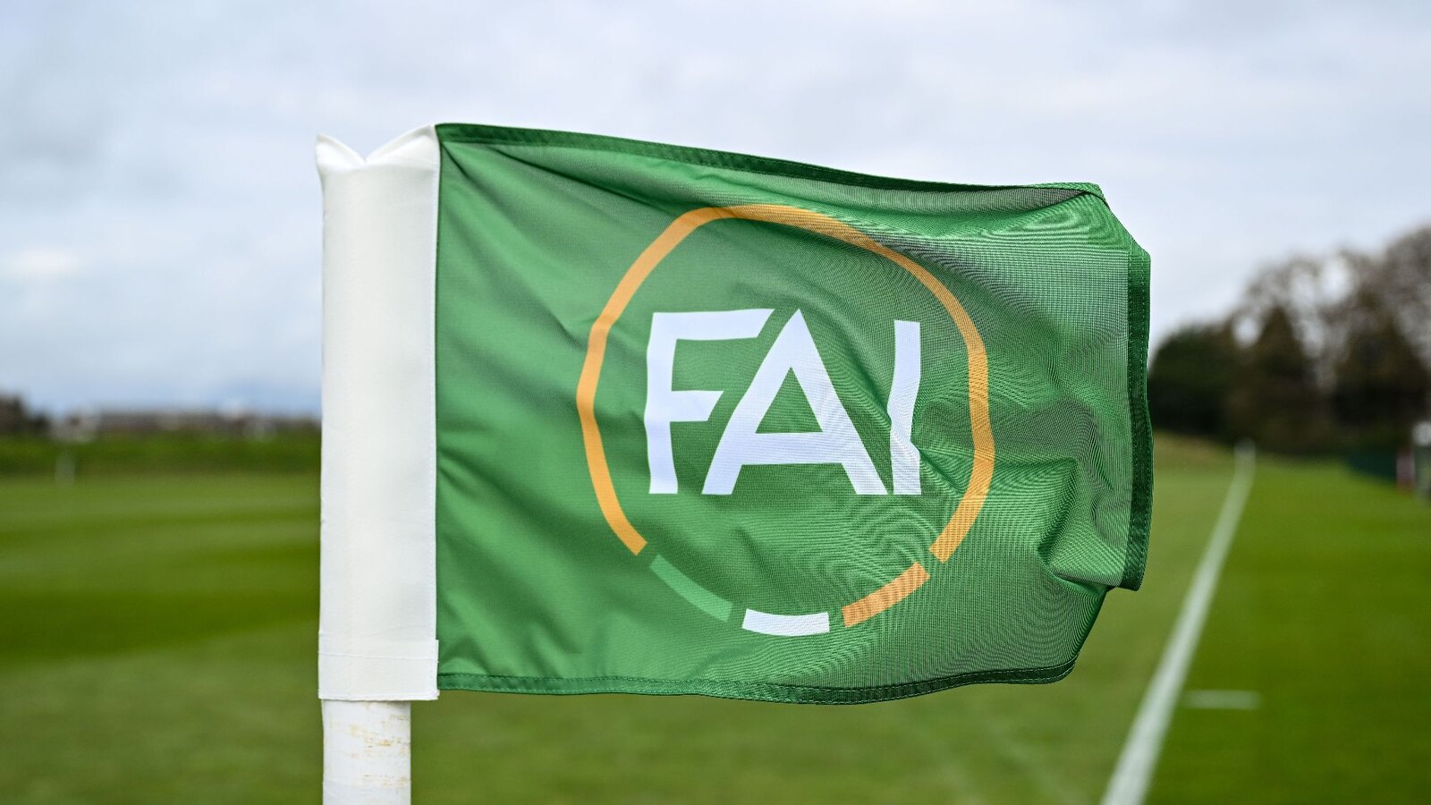 An FAI-branded corner flag beside a football pitch in an official Football Association of Ireland photograph