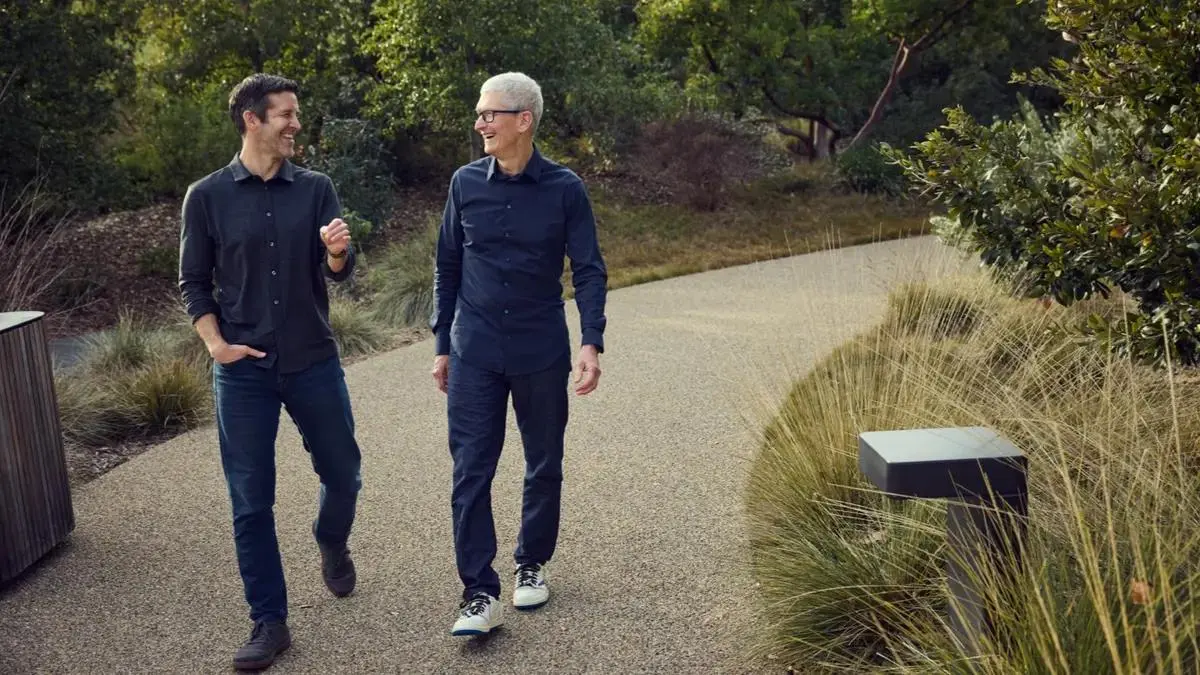 John Ternus and Tim Cook walking together at Apple Park