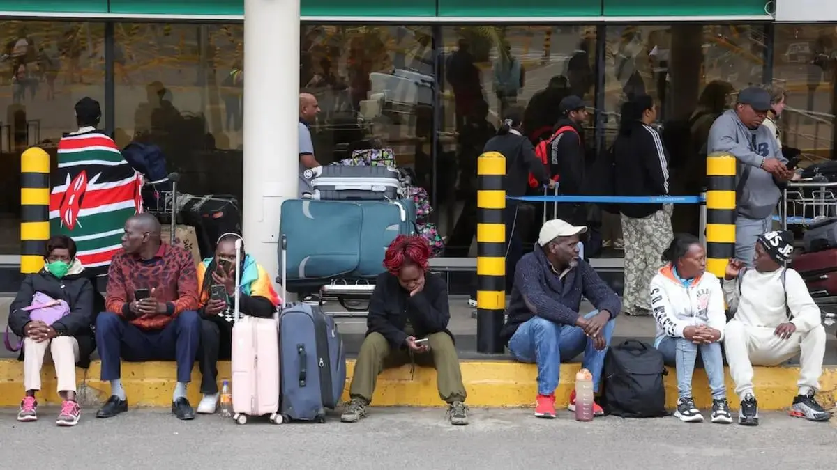Travellers wait with luggage at Jomo Kenyatta International Airport after the strike ended