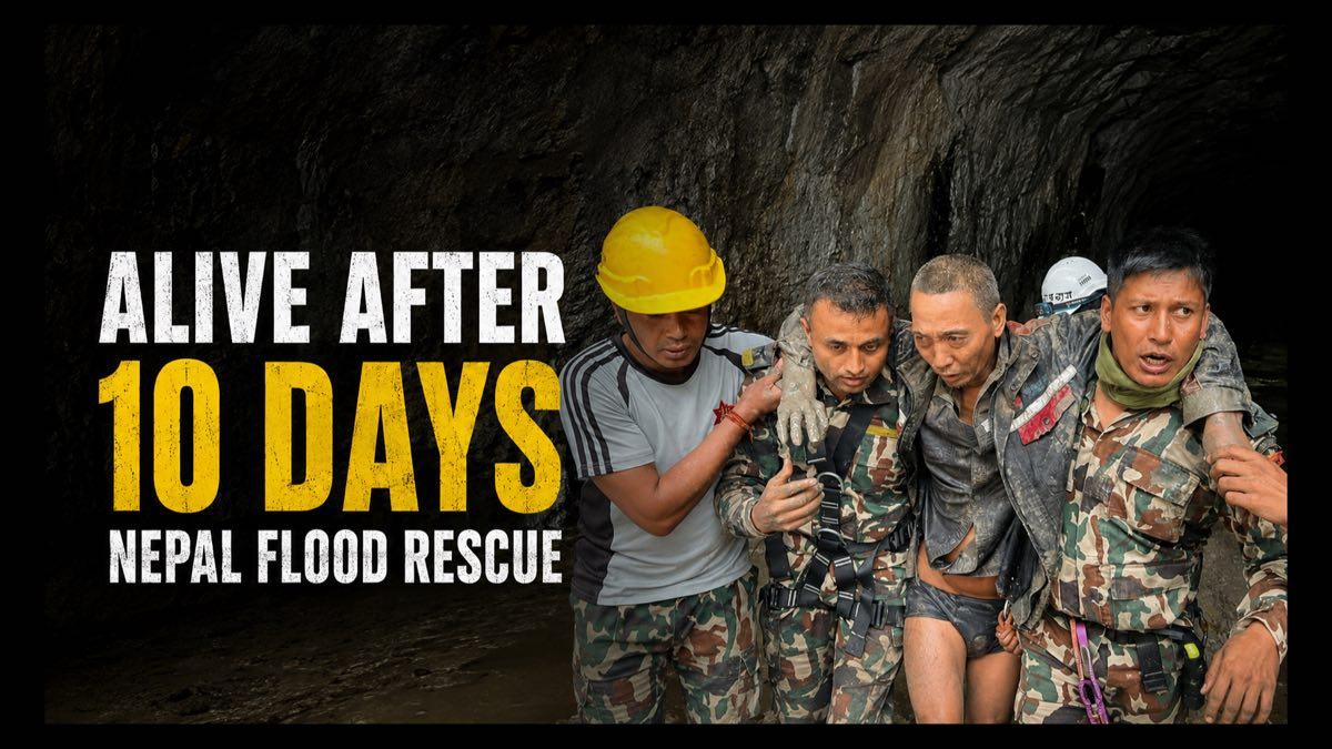 Nepalese rescue personnel helping a survivor from a flood-damaged tunnel