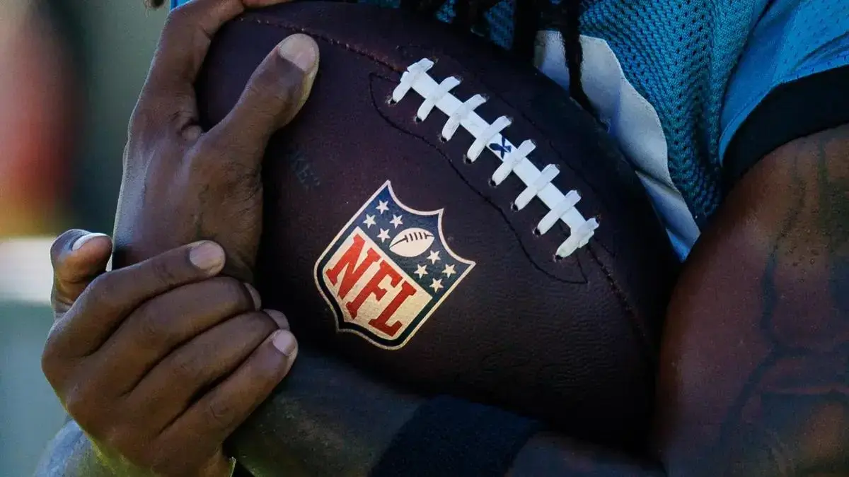 NFL-branded American football on a stadium field