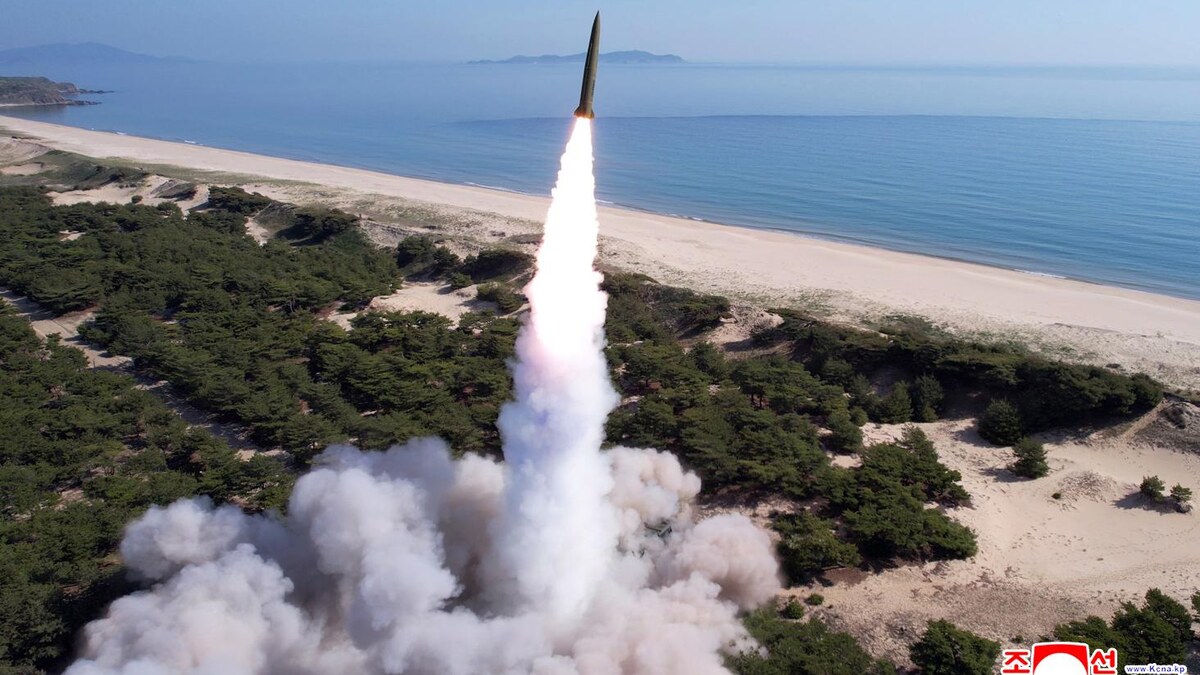 A real North Korean tactical ballistic missile rising from a coastal launch area in a 2025 file photograph