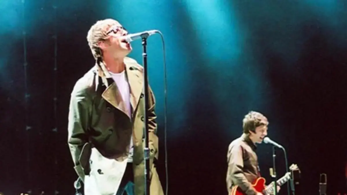 Oasis brothers Liam and Noel Gallagher performing together