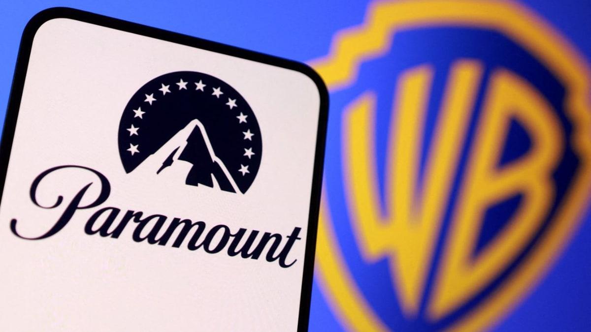 Paramount logo on a phone with the Warner Bros shield in the background