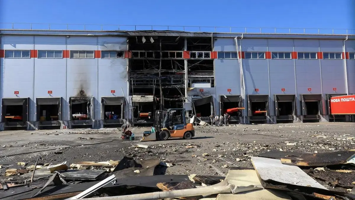 Workers clear debris after a Russian drone strike near Odesa, Ukraine