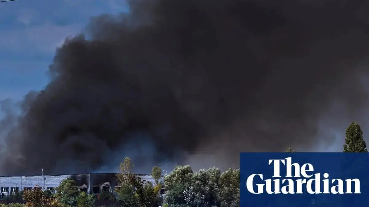 Emergency crews at a building damaged by a drone strike in Ukraine