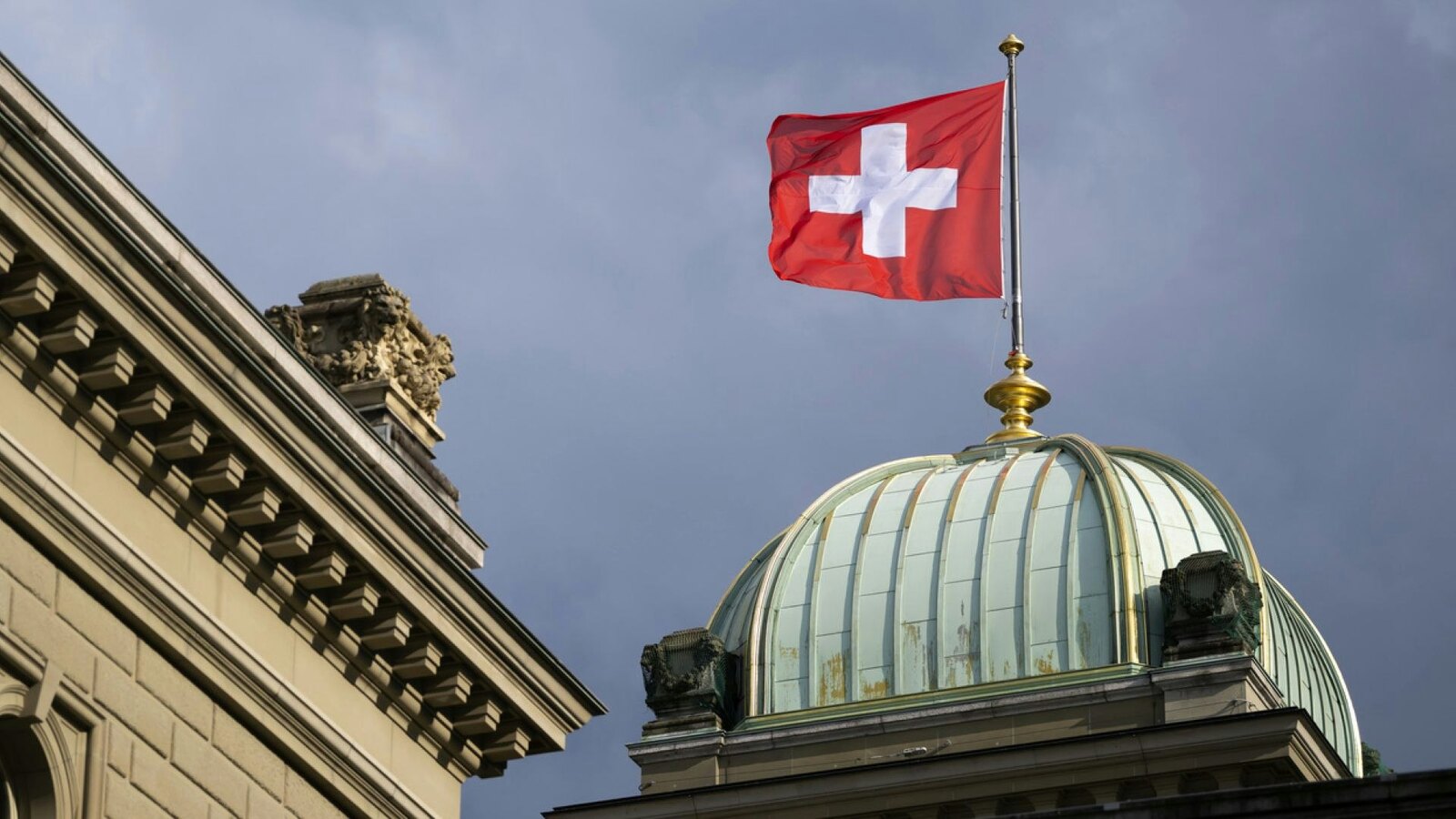 Swiss flag flying above the Federal Palace in an official Swiss government photograph