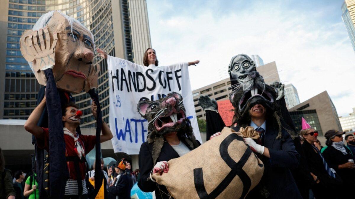 Demonstrators marching during the Canada Investment Summit in Toronto