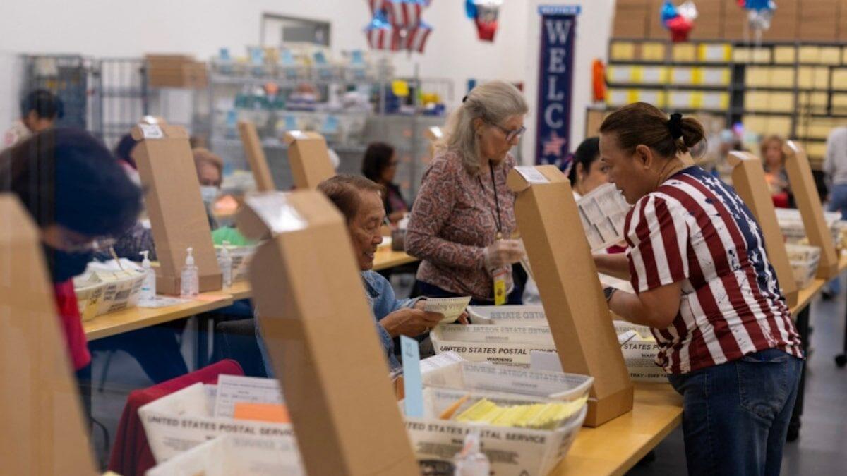 Election workers processing mail ballots in the United States
