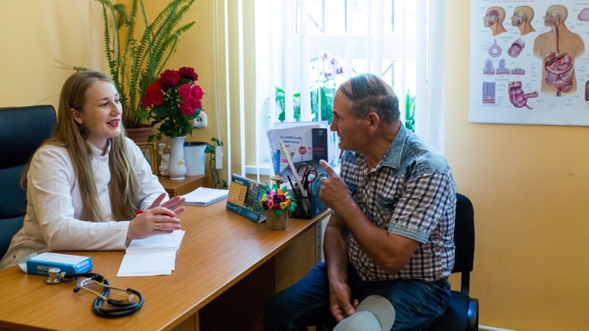 A health professional speaking with a patient during a clinical consultation